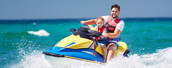 Father and son riding a Jet Ski