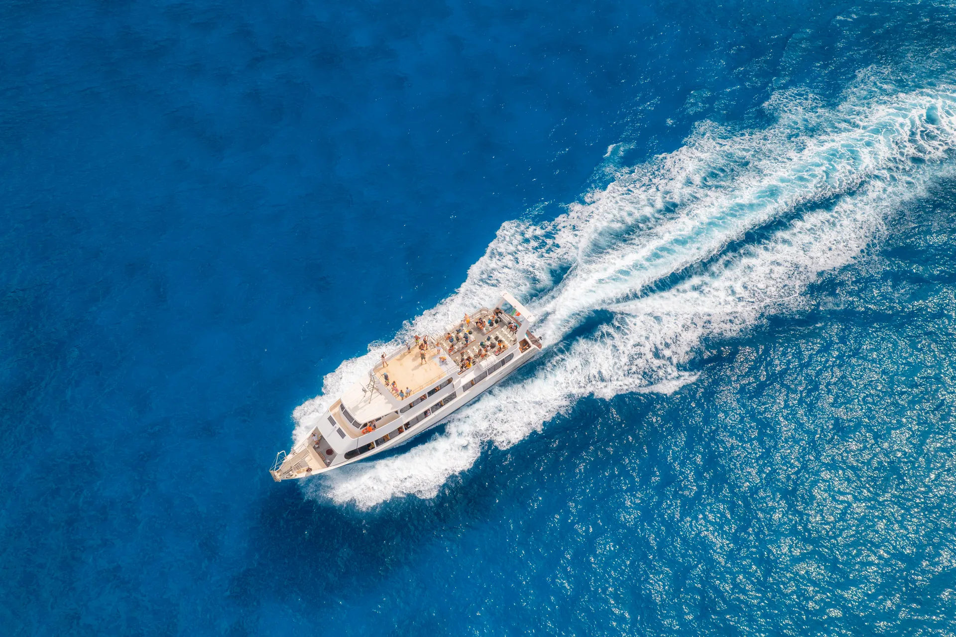 Aerial view of beautiful floating boat in blue sea