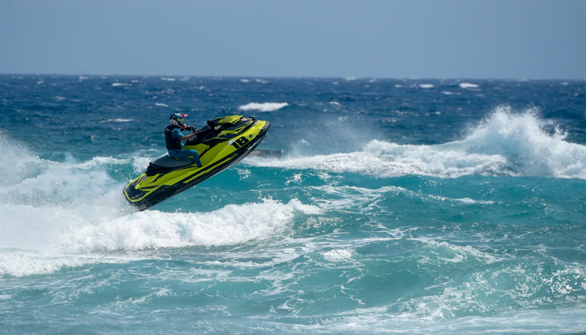 Man on water scooter jet ski against sea waves