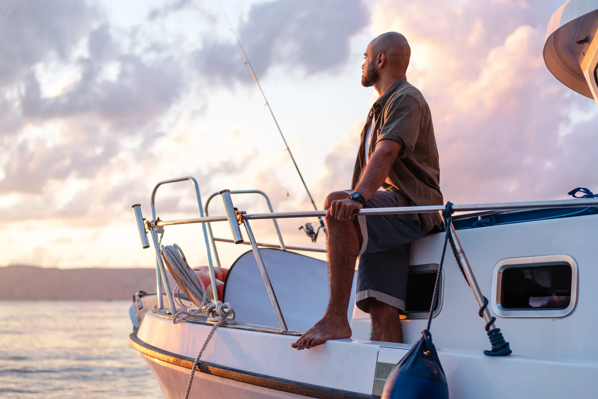 Young african american man standing with fishing